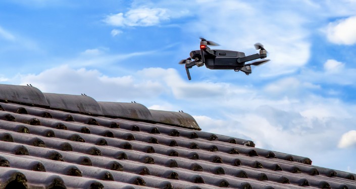A Mighty Dog Roofing drone performing an inspection of a clay tile roof