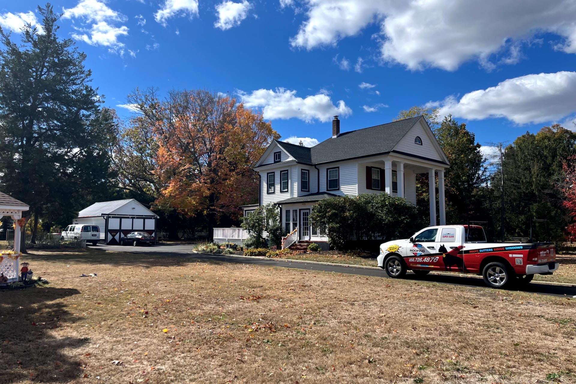 white house with new asphalt shingle roof 